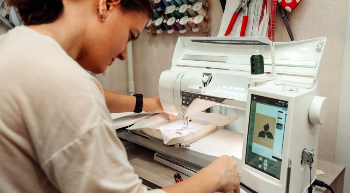 Woman embroidering on an embroidery machine.