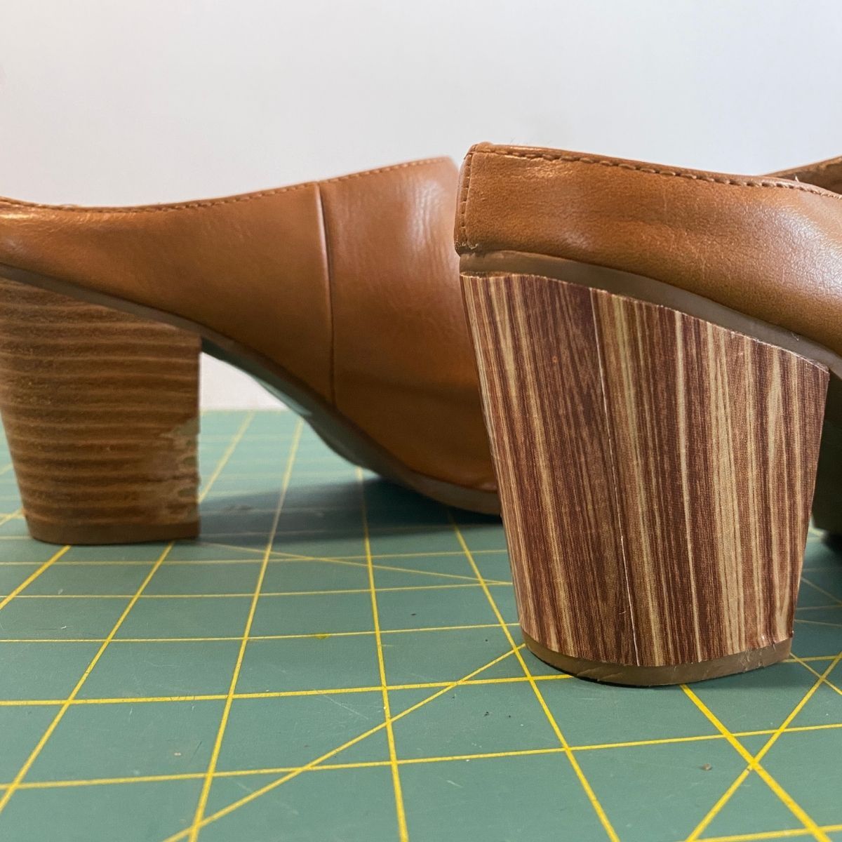 Damaged shoes, with one heel repaired with wood tape
